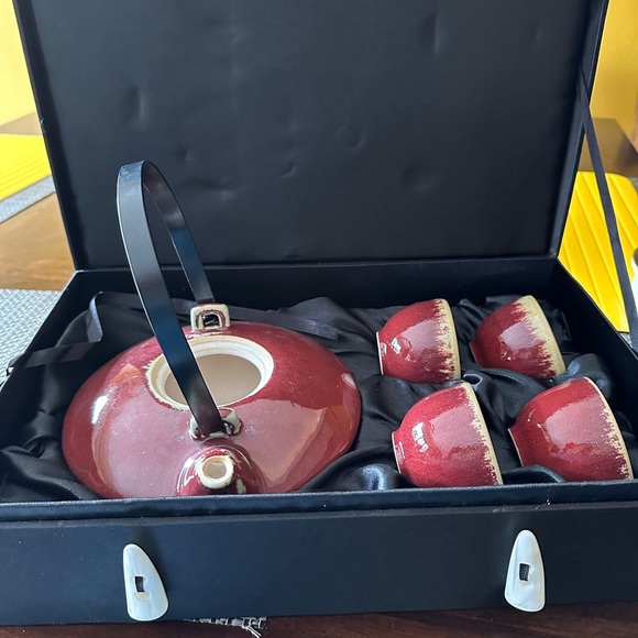 Collection of ceramic tea sets and cast iron tea pot. One set with case